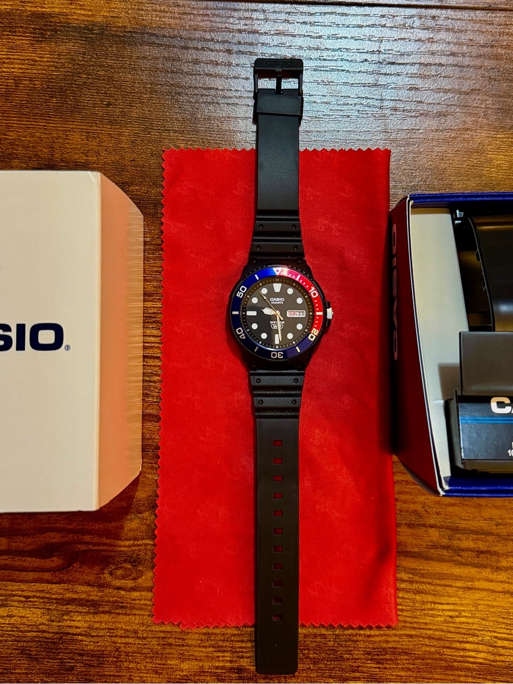 Casio Black Resin Strap Watch with Blue and Red Bezel
